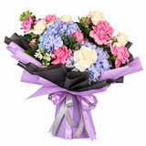 Flowrista pink and cream rose and blue hydrangea bouquet in black and lilac wrapping