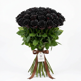 Black-sprayed rose bouquet with green foliage, long stems, brown ribbon and Flowrista gift tag