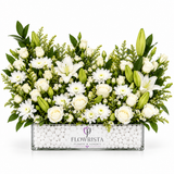Fresh white roses and lilies with greenery in a rectangular Flowrista box with white decorative pebbles