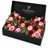 Flowrista black flower box with red, pink, peach and lavender blooms