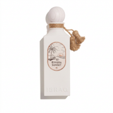 Riviera Sunset ivory perfume bottle with rounded cap, oval illustrated label and hanging charm