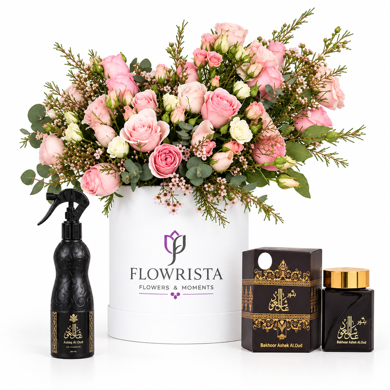 Ashiq Al Oud air freshener and bakhoor beside pink and cream roses in a white Flowrista box