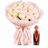 Asser perfume beside blush and cream rose bouquet with pink wrapping and Flowrista ribbon