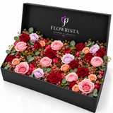 Fresh red pink lavender and peach roses with eucalyptus in an open black Flowrista gift box