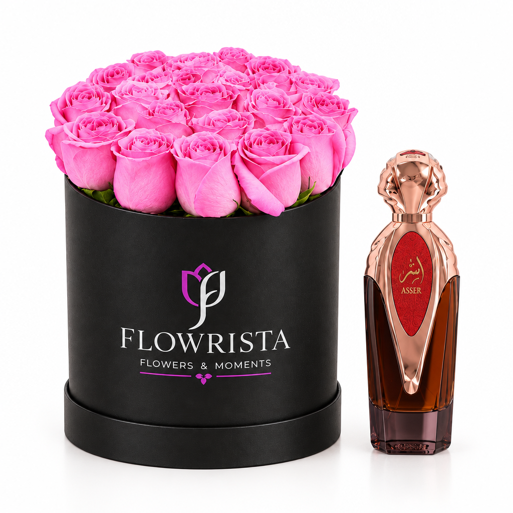 Asser perfume beside bright pink roses in a black round Flowrista flower box