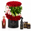 Asser perfume bakhoor and air freshener beside red roses and pink orchids in a black Flowrista box