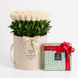 Patchi 1kg chocolate box with red ribbon beside white roses in a cream Flowrista hatbox
