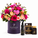 Ashiq Al Oud air freshener and bakhoor beside mixed roses in a purple Flowrista flower box