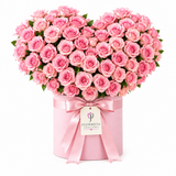 Flowrista heart-shaped pink rose arrangement in a pink box with satin bow and branded tag