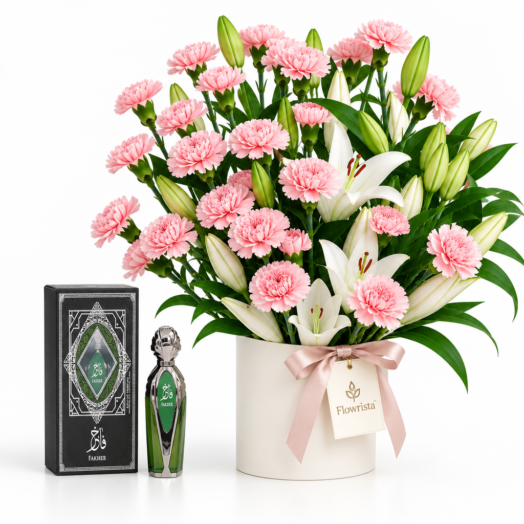 Fakher perfume and presentation box beside Flowrista pink carnations and white lilies in a white flower container