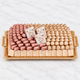 Assorted Belgian chocolates individually wrapped on an elegant gold gift tray
