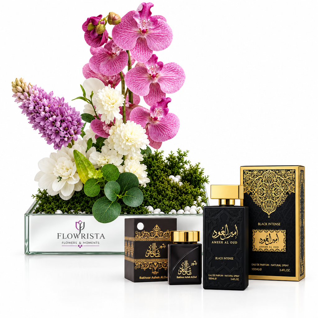 Black Intense perfume and bakhoor beside pink orchids and white flowers in a mirrored Flowrista tray