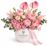 Pink anthuriums, ranunculus and mixed flowers with eucalyptus in a white Flowrista vase and pink ribbon