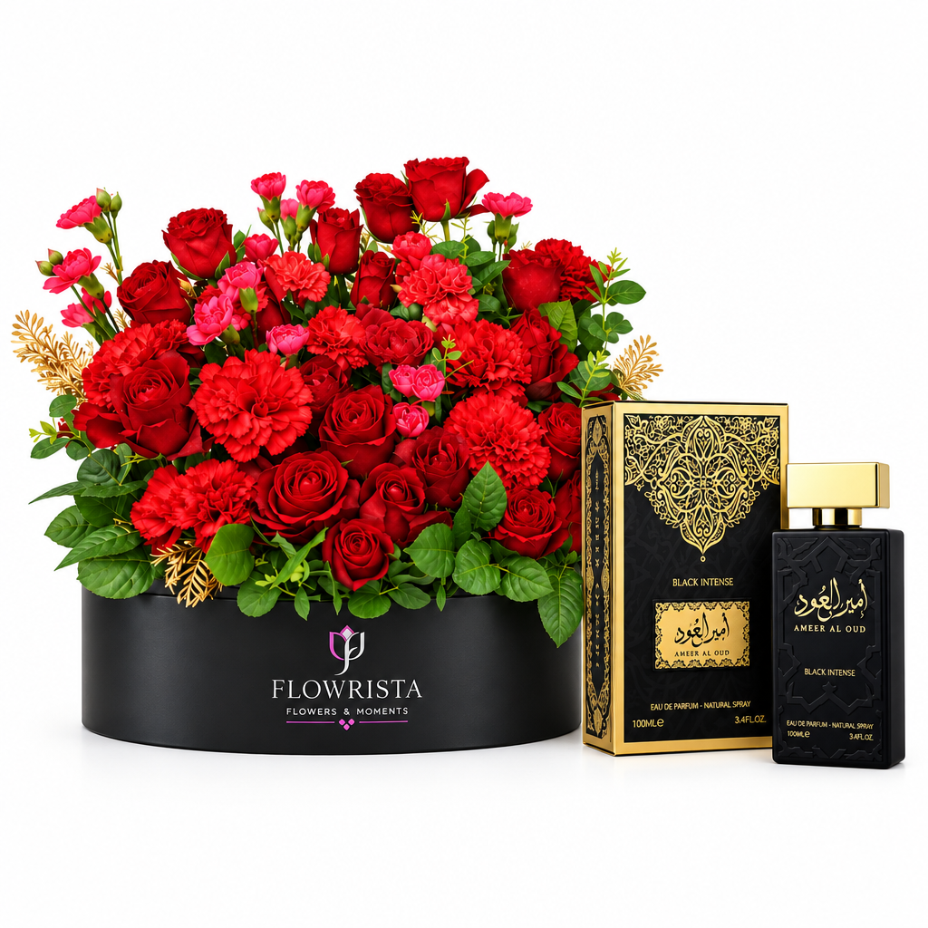 Black Intense perfume beside red roses and carnations in a wide black Flowrista box