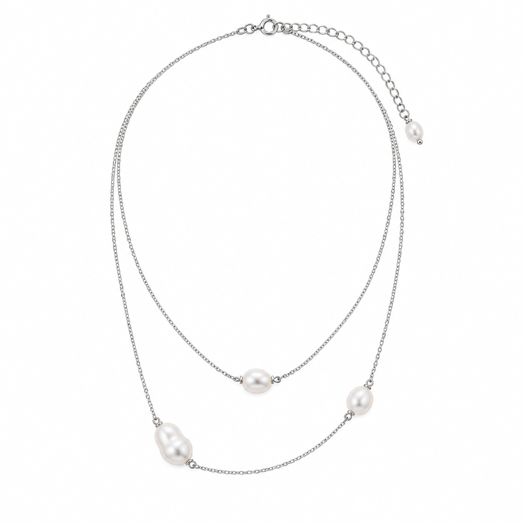 Delicate silver-tone necklace with pearl-like accents on white background