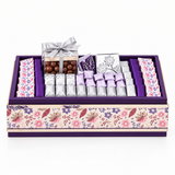Assorted chocolates in a purple floral-patterned Belgian chocolate gift tray