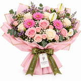 Pink roses, gerberas and white anthuriums in Flowrista pink wrap with olive bow