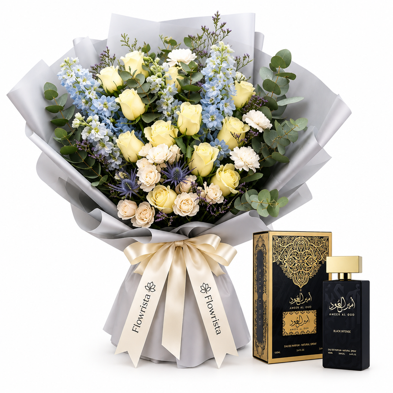 Amir Al Oud Black Intense perfume and box beside a cream rose and pale-blue flower bouquet