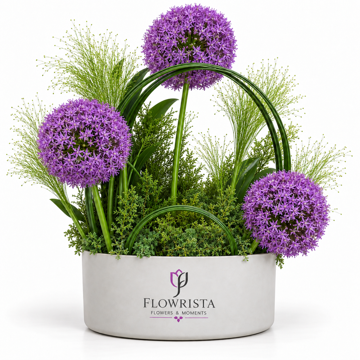 Flowrista purple allium arrangement with lush greenery in a white oval vase