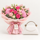 White Call It Spring top-handle bag beside a Flowrista pink rose and hydrangea bouquet