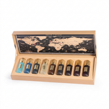 Tobacco Collection perfume bottles in an open tan presentation case with a world-map design inside the lid