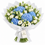 Flowrista blue hydrangeas and white lisianthus with green buds in white wrapping and a white satin ribbon