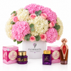 Asser perfume Mamoul and Bakhoor Saher Al Kalmat beside Flowrista pink hydrangeas and roses in a white box