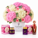 Asser perfume Mamoul and Bakhoor Saher Al Kalmat beside Flowrista pink hydrangeas and roses in a white box