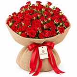 Flowrista red spray rose bouquet in natural burlap with red satin bow and branded tag