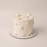One-kilo Sugar Sweet white celebration cake with seashell, pearl and butterfly decorations