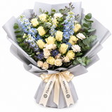 Flowrista cream roses and pale-blue flowers with eucalyptus in grey wrapping and a cream ribbon