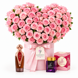 Asser perfume and Bakhoor Saher Alkalmet beside Flowrista heart-shaped pink roses in a pink box