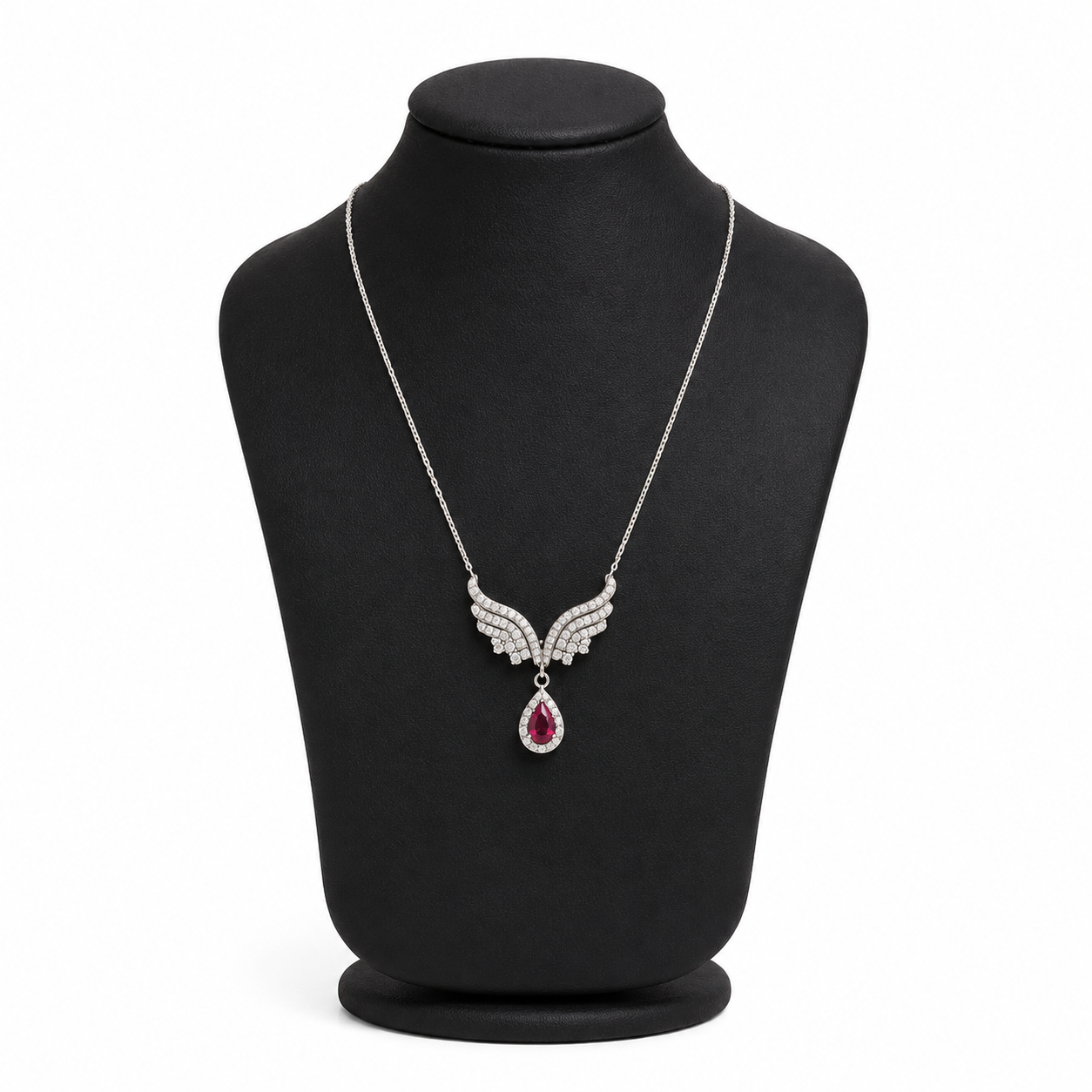Silvara platinum-plated angel wing necklace with ruby red zircon teardrop pendant on black jewelry bust