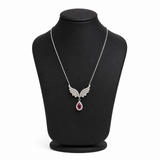 Silvara platinum-plated angel wing necklace with ruby red zircon teardrop pendant on black jewelry bust