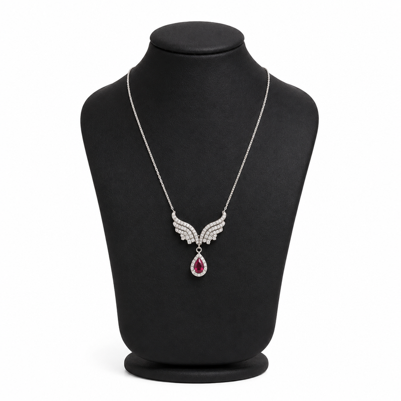Silvara platinum-plated angel wing necklace with ruby red zircon teardrop pendant on black jewelry bust