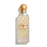Perfume bottle with gold cap and iridescent label on a white background