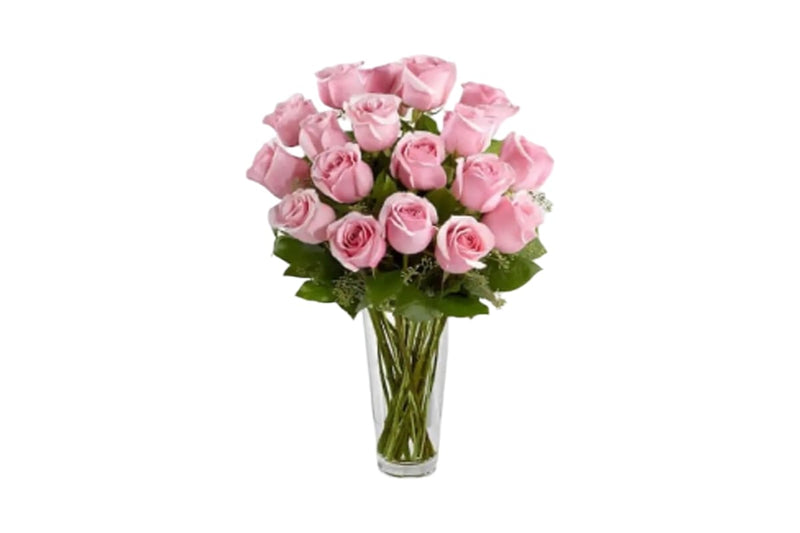 A bouquet of 15 pink roses in a clear glass vase with green stems, set against a plain white background.