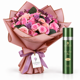 A bouquet of pink and purple roses wrapped in pink paper with a purple ribbon and a tag reading FLOWBISTA, shown next to a green cylindrical bottle labeled Roseine Lotion Mist on a white background.