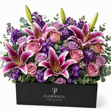 "Into the Night Flower Gift Box — dramatic pink oriental lilies, mauve and pink roses, purple statice, and eucalyptus in a Flowrista signature black gift box"