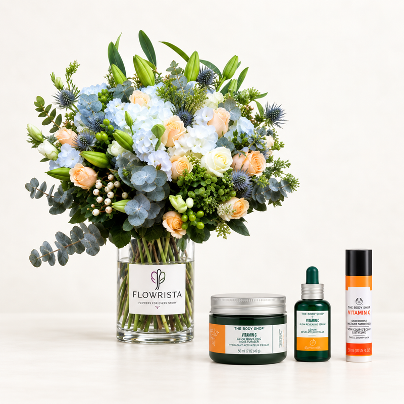 A styled product arrangement on a clean white background featuring a large floral bouquet in a clear glass vase labeled FLOWRISTA, alongside skincare products from The Right Sort including a green body butter jar, a green vitamin serum dropper bottle, and a white vitamin roll-on with orange accents.