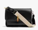 A black leather crossbody bag with a wide beige fabric shoulder strap and gold-tone hardware, shown against a plain white background.