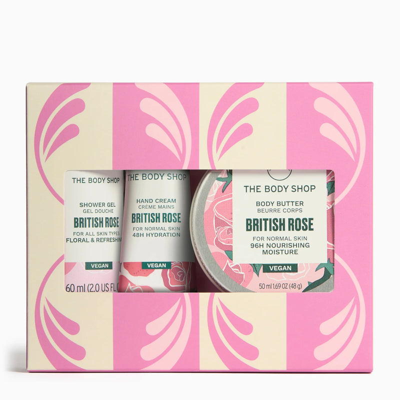The Body Shop British Rose gift set containing shower gel, hand cream, and body butter in a pink and cream patterned box with a clear window.