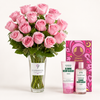 A large bouquet of pink roses in a clear glass vase with a visible Flowrista label, displayed beside two cherry blossom-themed body care products and a pink patterned box labeled Cherry Blossom on a clean white background.