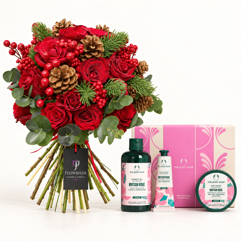 A festive gift set featuring a large bouquet of red roses with pinecones, eucalyptus, and red berries, alongside The Body Shop body care items including a body wash, hand cream, and body butter, and a pink gift box. The bouquet is branded with a Flowerista tag.