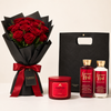 A Valentine's Day gift set featuring a bouquet of 24 red roses in black wrapping with a red ribbon, a Bath & Body Works 'Forever Red' body wash bottle, a body lotion bottle, and a Strawberry Punch bath bomb jar, alongside a black gift bag.