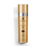 A tall cylindrical bottle of Arabian Gold Room & Linen Mist on a clean white background. The bottle is metallic gold with a silver band near the top and elegant black text detailing the brand and product name.