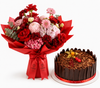 A red and pink flower bouquet wrapped in red paper with a red ribbon, placed beside a chocolate cake with chocolate shavings and a red ribbon on a white background.