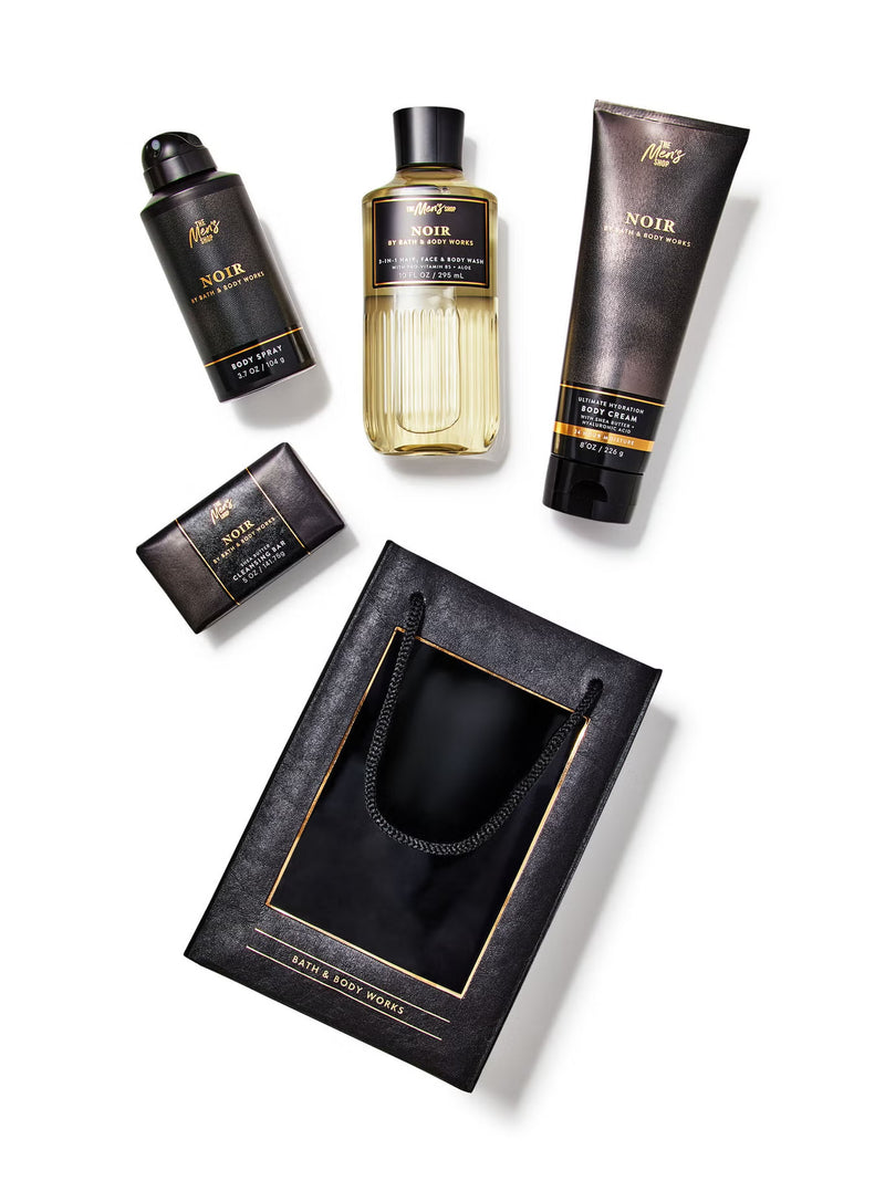 Collection of Noir grooming products including bottles and a pouch on a white background