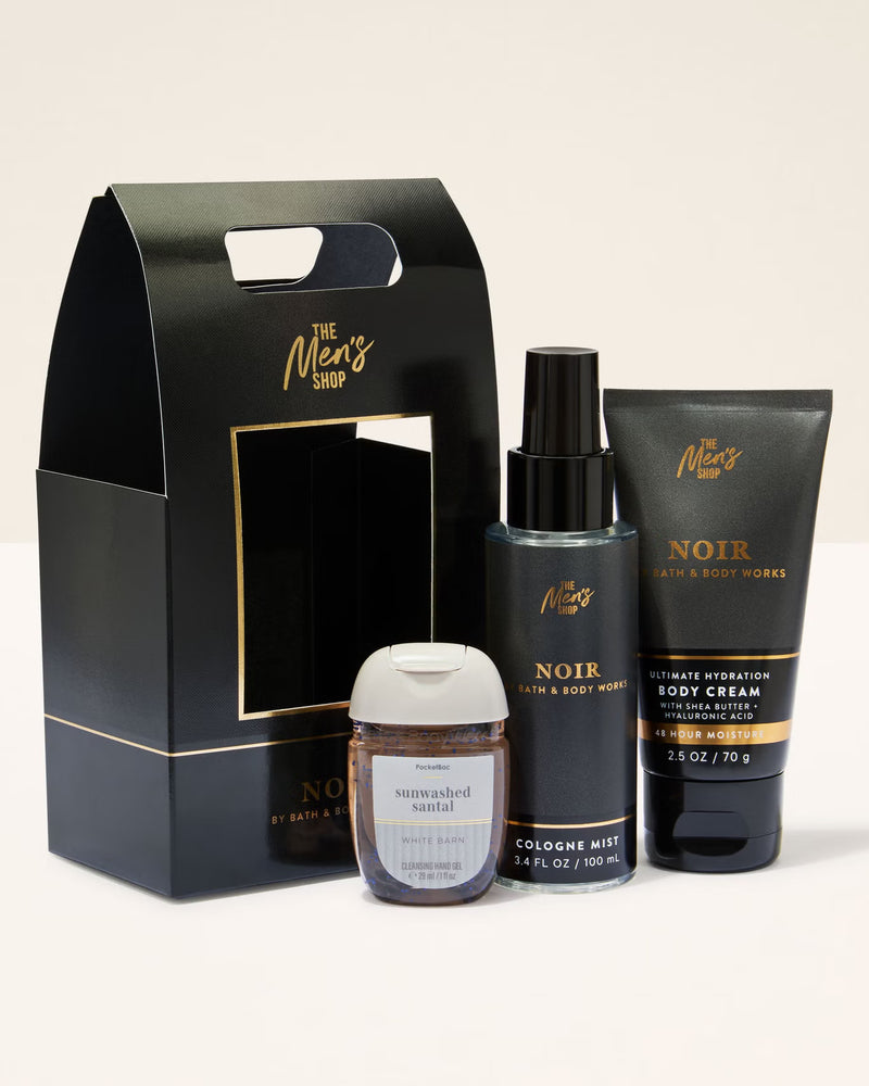 Men's grooming products including a cologne, body wash, and body cream in front of a branded box.