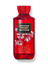 A 10 fl oz bottle of Bath & Body Works Japanese Cherry Blossom body wash, featuring a vibrant red translucent bottle with cherry blossom illustrations and a black label with gold lettering.